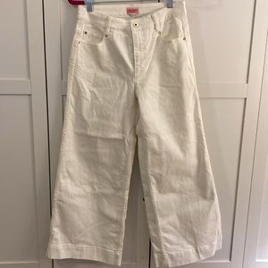 White wide-leg Kate spade jeans with gold buttons and detailing